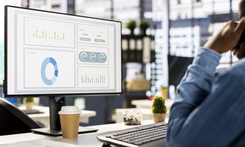 Businessman studying infographics and performance metrics for decision making, focused on project goals. Executive assistant managing business tasks and reviewing data, showcasing expertise.